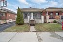 Bungalow featuring a front lawn, covered porch, roof with shingles, and brick siding - 106 Lottridge Street, Hamilton, ON  - Outdoor With Facade 