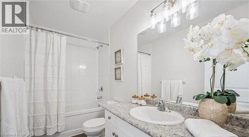 Full bath featuring vanity and shower / bath combo with shower curtain - 24 Morrison Road Unit# D9, Kitchener, ON - Indoor Photo Showing Bathroom