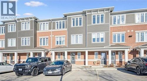 View of building exterior with uncovered parking - 24 Morrison Road Unit# D9, Kitchener, ON -  With Facade