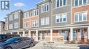 View of building exterior featuring uncovered parking and a residential view - 24 Morrison Road Unit# D9, Kitchener, ON  - Outdoor With Facade 
