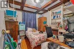 Bedroom featuring coffered ceiling, hardwood / wood-style floors, and beam ceiling - 