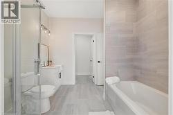 Bathroom with vanity, a bath, and a shower stall - 