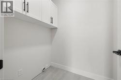 Laundry area with cabinet space and baseboards - 