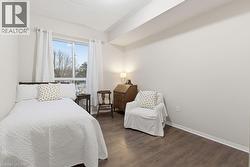 Bedroom featuring dark wood-style flooring and baseboards - 