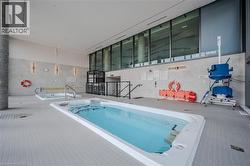 View of swimming pool with a hot tub and a patio - 