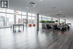 Community lobby featuring expansive windows and a view of city - 