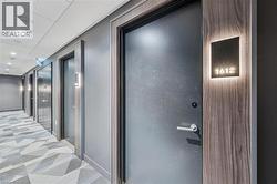 Corridor with light colored carpet, recessed lighting, and elevator - 