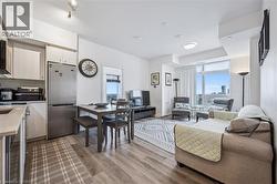 Living area with plenty of natural light, light wood finished floors, and beverage cooler - 