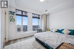 Bedroom featuring wood finished floors and baseboards - 