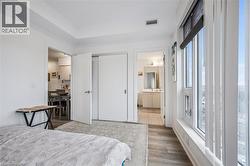 Bedroom featuring a closet, ensuite bath, and light wood-type flooring - 