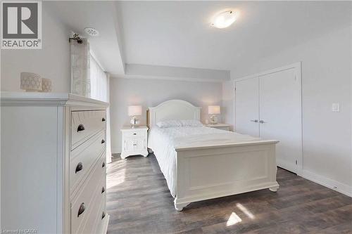 Bedroom with a closet and dark wood-type flooring - 588 Rapids Lane, Mississauga, ON - Indoor Photo Showing Bedroom