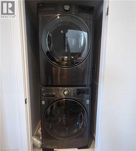 Laundry room with stacked washer / dryer - 588 Rapids Lane, Mississauga, ON - Indoor Photo Showing Laundry Room
