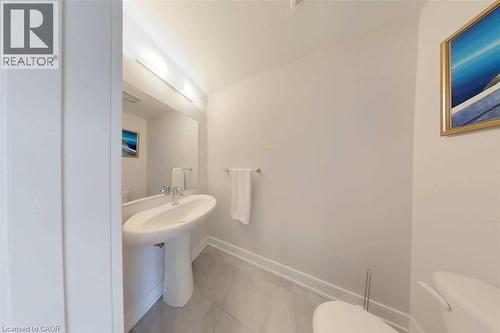 Half bathroom with toilet and light tile patterned floors - 588 Rapids Lane, Mississauga, ON - Indoor Photo Showing Bathroom