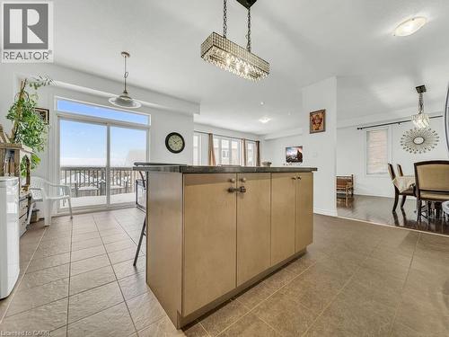 Kitchen featuring pendant lighting, healthy amount of natural light, dark countertops, and a center island - 3 Creighton Avenue, Guelph, ON - Indoor