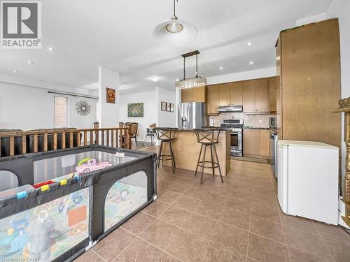 Kitchen featuring a kitchen bar, appliances with stainless steel finishes, decorative light fixtures, decorative backsplash, and recessed lighting - 3 Creighton Avenue, Guelph, ON - Indoor Photo Showing Kitchen