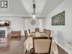 Dining space featuring a glass covered fireplace and dark wood-style floors - 