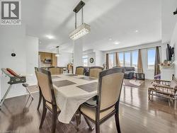 Dining room with dark wood finished floors, plenty of natural light, and recessed lighting - 