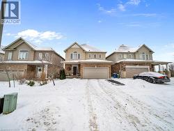 View of front of home with brick siding and an attached garage - 