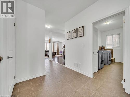 Hallway featuring washing machine and dryer and light tile patterned floors - 3 Creighton Avenue, Guelph, ON - Indoor Photo Showing Other Room