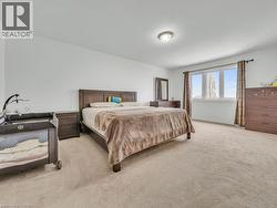 Bedroom featuring light colored carpet and baseboards - 