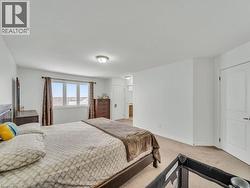 Bedroom with light colored carpet and baseboards - 