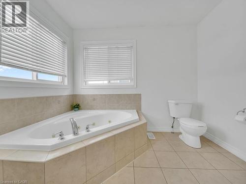 Full bathroom featuring a whirlpool tub and light tile patterned flooring - 3 Creighton Avenue, Guelph, ON - Indoor Photo Showing Bathroom