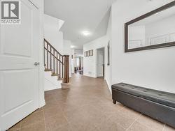 Entryway with stairs and light tile patterned floors - 