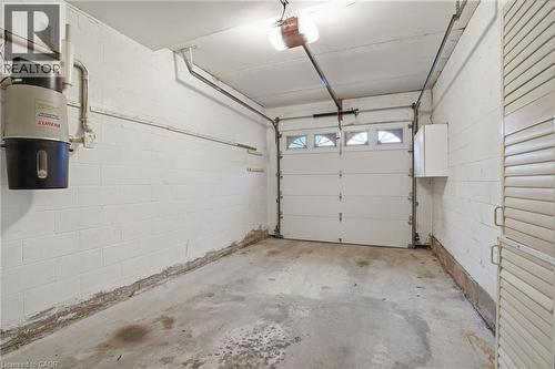 Garage featuring a central vacuum unit and a garage door opener - 3230 New Street Unit# 7, Burlington, ON - Indoor Photo Showing Garage