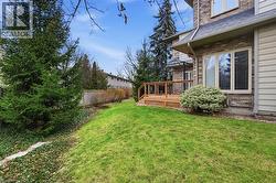 View of yard featuring a wooden deck - 
