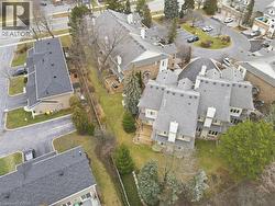 Aerial view of property's private ocation featuring trees and gardens - 