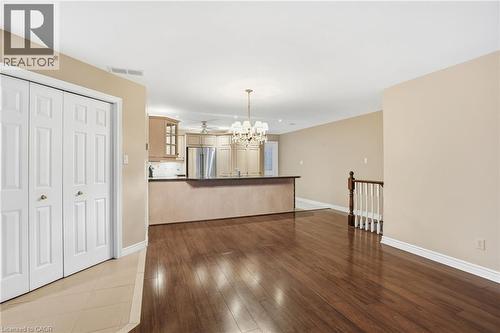 Unfurnished dining area with a chandelier and dark wood finished floors - 3230 New Street Unit# 7, Burlington, ON - Indoor