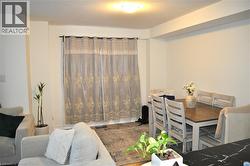 Dining space with wood finished floors and a textured ceiling - 