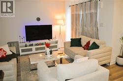 Living area featuring wood finished floors and baseboards - 