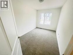 Carpeted empty room with baseboards - 