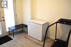 Washroom with light wood-style flooring and baseboards - 