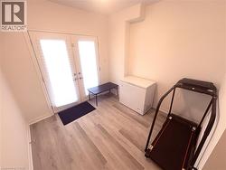 Entryway with french doors and light wood finished floors - 