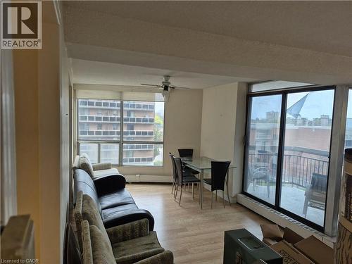 See the Alternate Specifications link to see how this room could look if and when furnished. Open-concept living area featuring wood-finish flooring, a ceiling fan, and large windows - 150 Charlton Avenue E Unit# 402, Hamilton, ON - Indoor Photo Showing Living Room