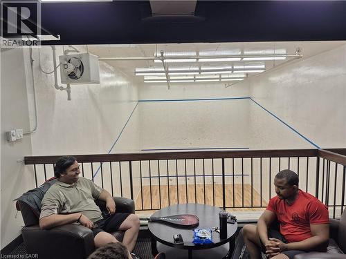 Indoor court with wood-finish flooring and marked playing lines - 150 Charlton Avenue E Unit# 402, Hamilton, ON - Indoor Photo Showing Other Room