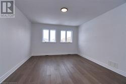 Unfurnished room with dark wood-type flooring - 
