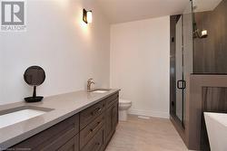 Full bathroom featuring vanity, toilet, and plus walk in shower - 