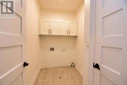 Washroom featuring hookup for a washing machine and cabinets - 