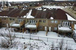 View of snow covered back of property - 