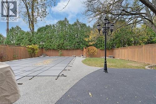 View of swimming pool with a fenced backyard and rubber paved patio - 90 Westlawn Drive, Hamilton, ON - Outdoor