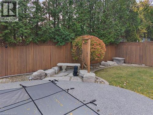 Fenced backyard featuring a rubber paved patio - 90 Westlawn Drive, Hamilton, ON - Outdoor