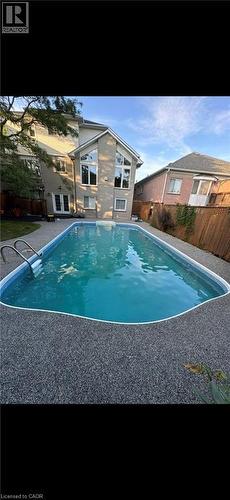 View of pool with a fenced backyard and french doors - 90 Westlawn Drive, Hamilton, ON - Outdoor With In Ground Pool With Backyard