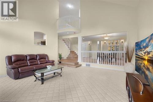 Lfamily room with high vaulted ceiling, light carpet, plenty of natural light, and a gas fireplace - 90 Westlawn Drive, Hamilton, ON - Indoor