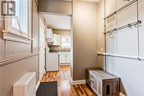 Laundry room featuring light wood-style flooring and a sink - 172 Markland Street, Hamilton, ON - Indoor