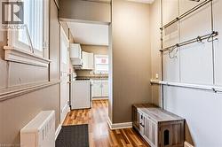 Laundry room featuring light wood-style flooring and a sink - 