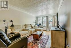Living room featuring wood finished floors and a textured ceiling - 