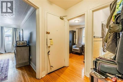 Hallway featuring light wood-style floors and a textured ceiling - 172 Markland Street, Hamilton, ON - Indoor Photo Showing Other Room